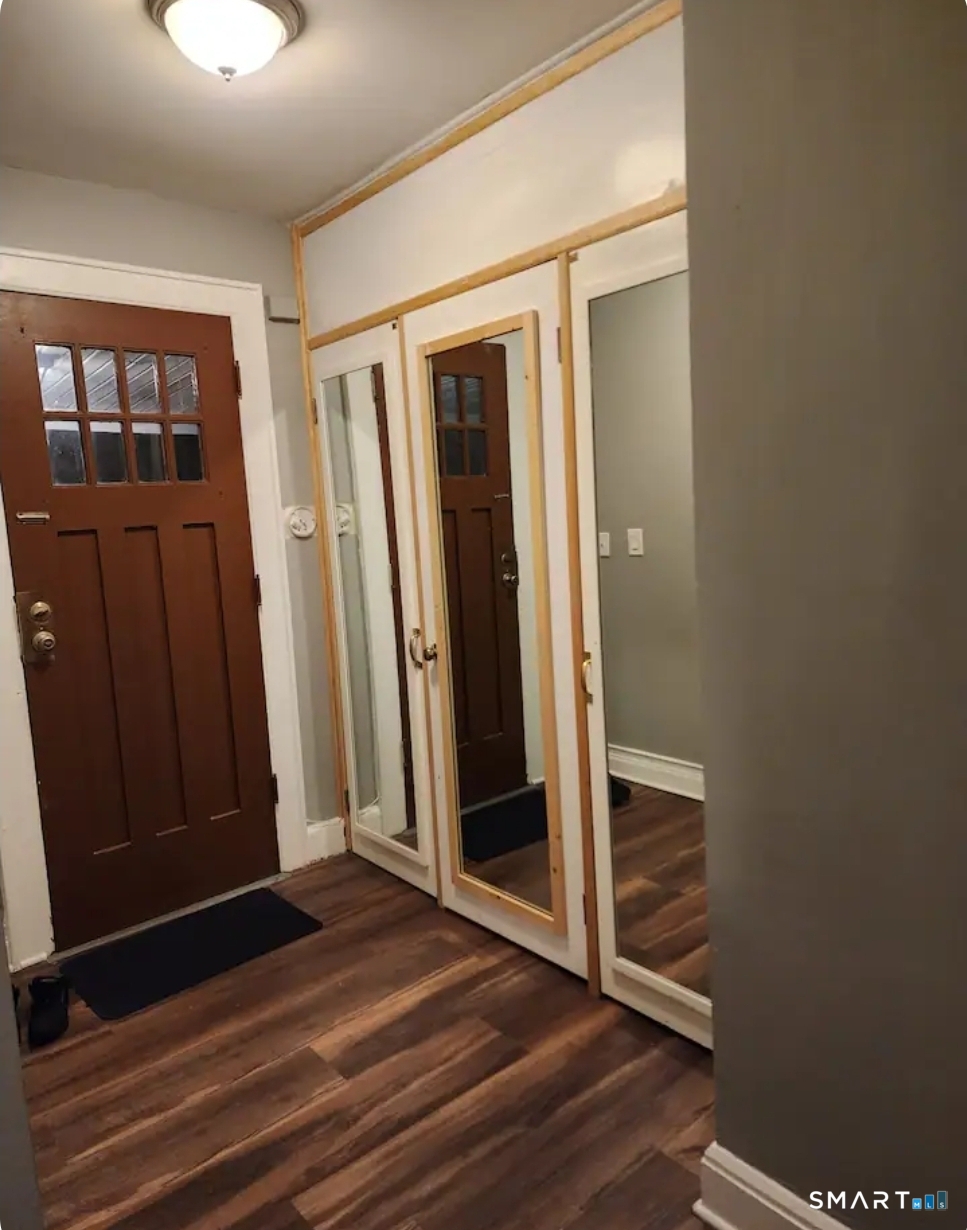 183 Harlem Avenue Bridgeport, CT 06606 - Photo 2 of 12 a view of a hallway with wooden floor and closet