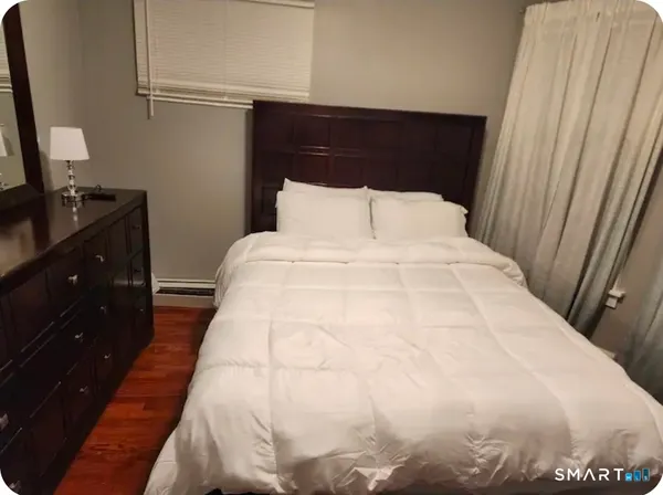 a large bed in a bedroom with a mirror