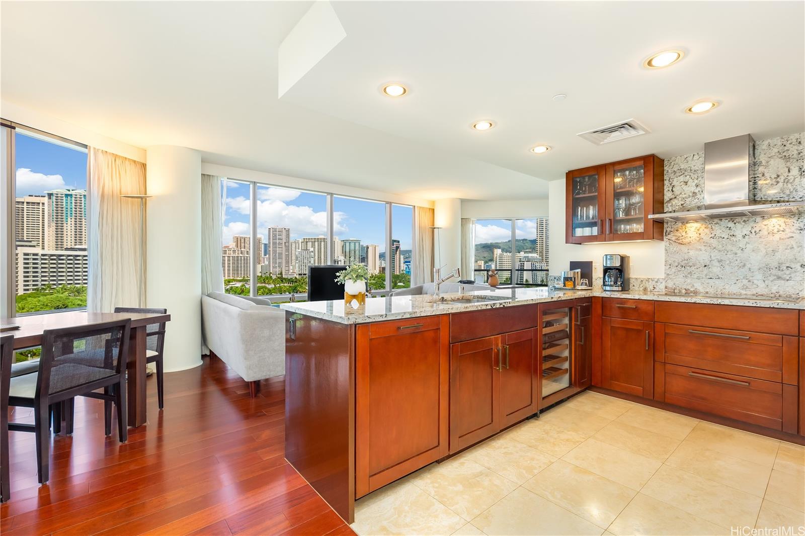 223 Saratoga Road, Unit 1103 Honolulu, HI 96815 - Photo 1 of 1 a large kitchen with stainless steel appliances granite countertop a large window and white cabinets