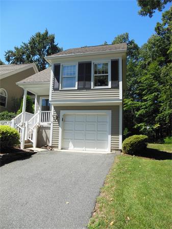 2 Shady Brook, Unit 2 West Springfield, MA 01089 - Photo 2 of 28 a front view of a house with a garden and trees