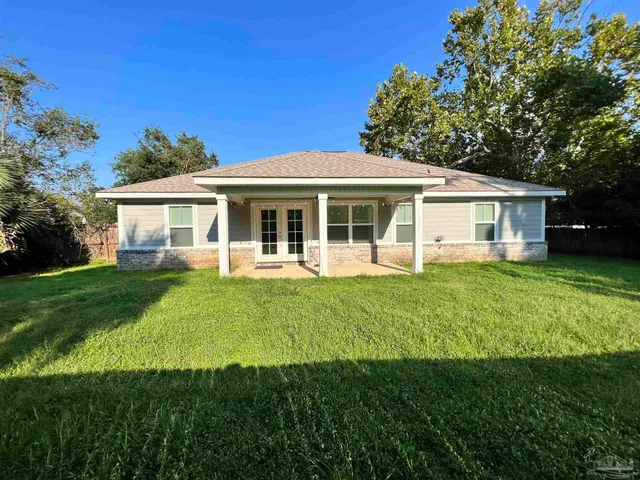 a front view of a house with a yard table and chairs