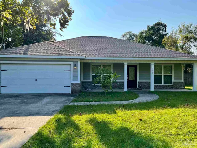 a view of a house with a backyard