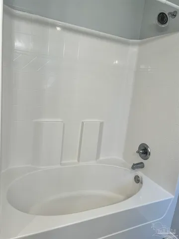a white bath tub sitting in a bathroom