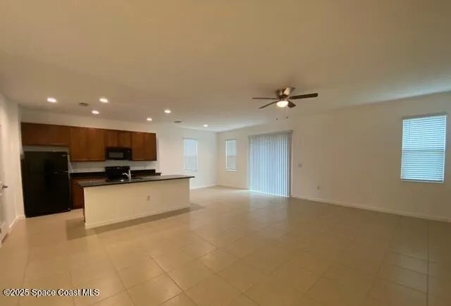 a view of kitchen with kitchen island microwave and stove