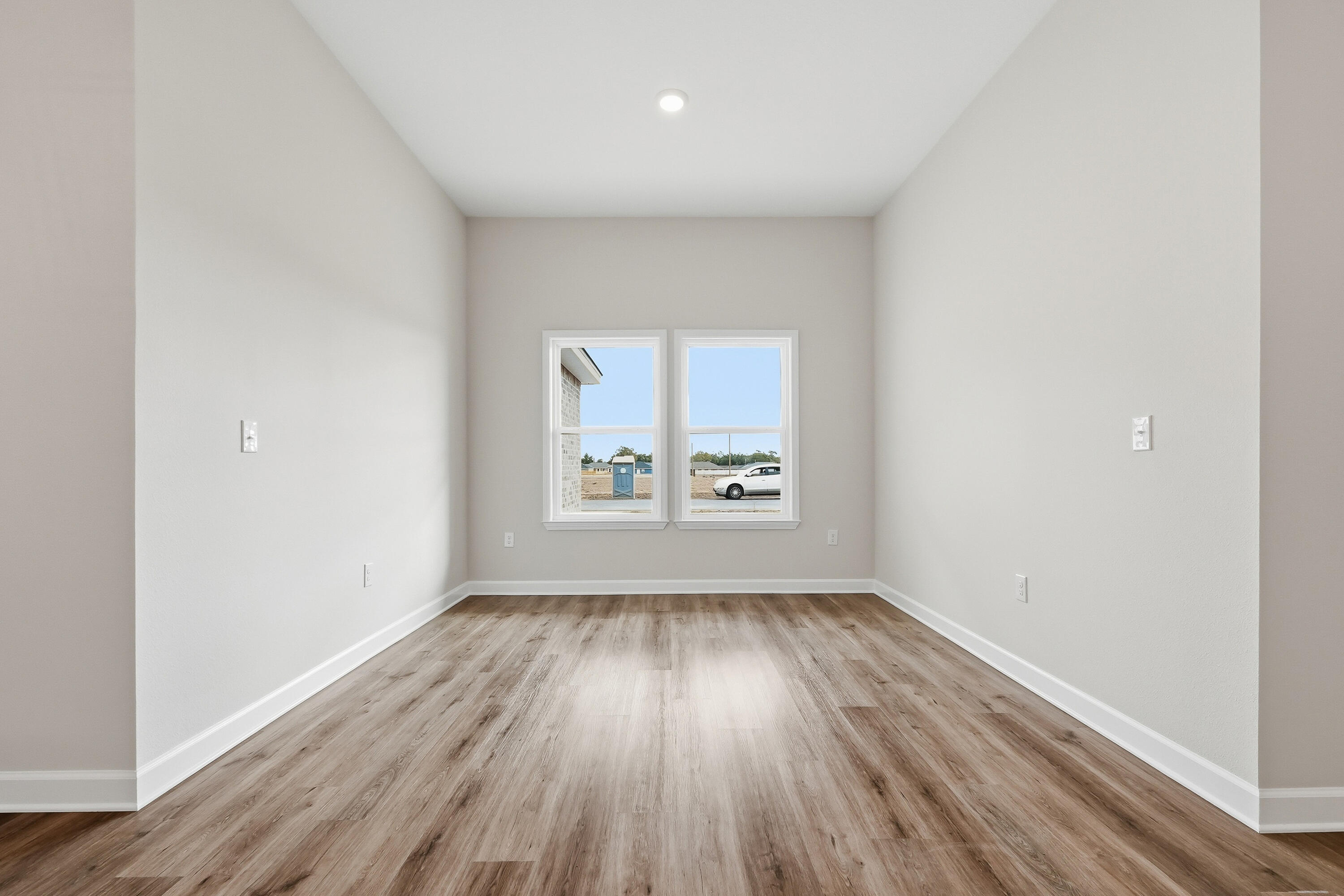 6105 Mildreds Way Crestview, FL 32539 - Photo 13 of 28 an empty room with wooden floor and windows