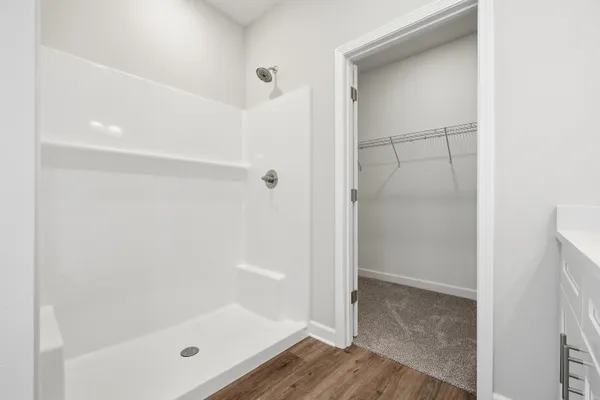 a bathroom with a glass shower door