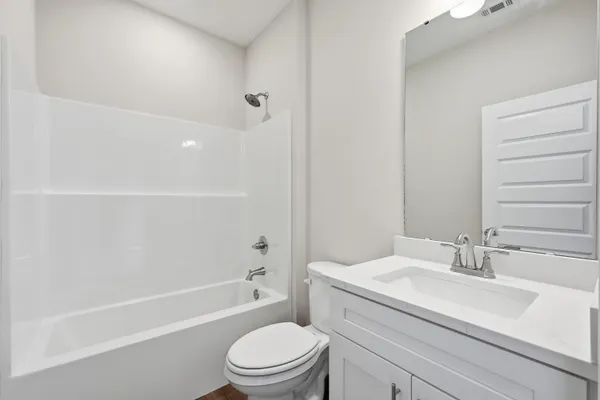 a bathroom with a sink a toilet and a bathtub