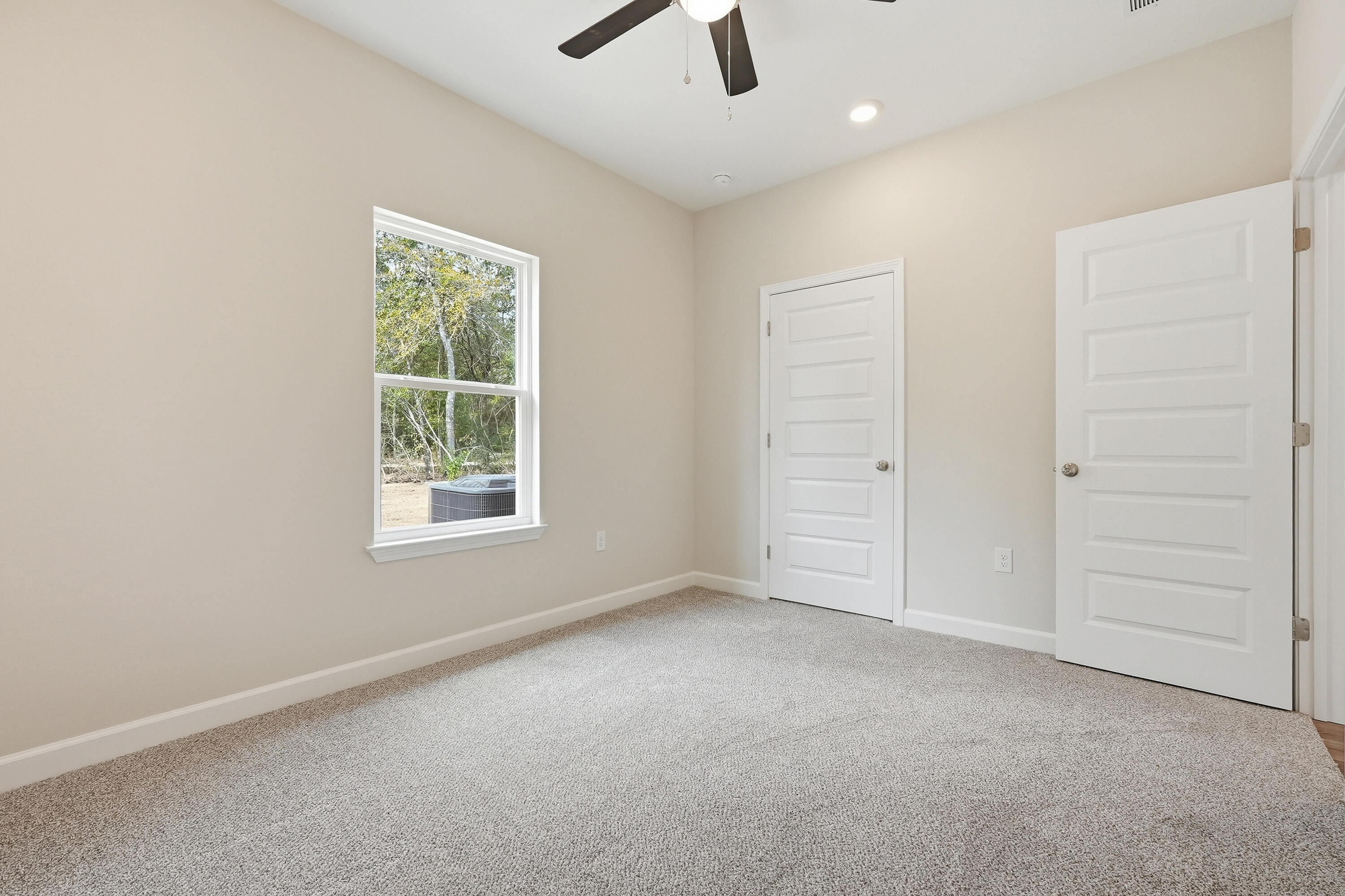 6105 Mildreds Way Crestview, FL 32539 - Photo 22 of 28 an empty room with a ceiling fan and a window