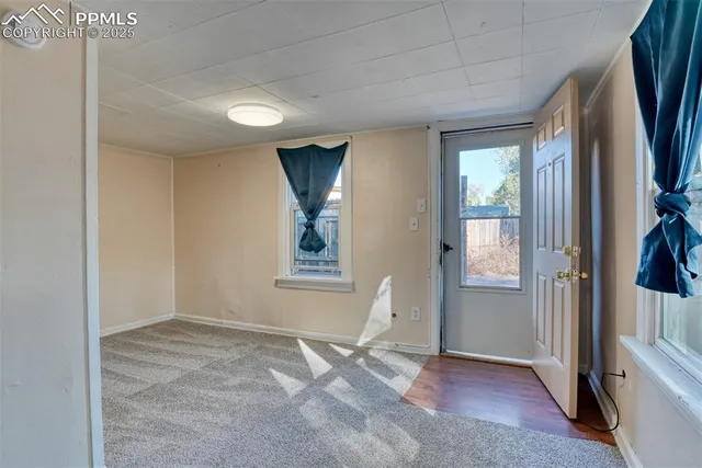 an empty room with windows and closet