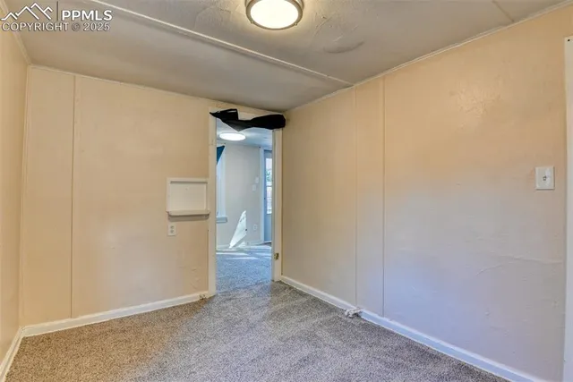 an empty room with windows and closet