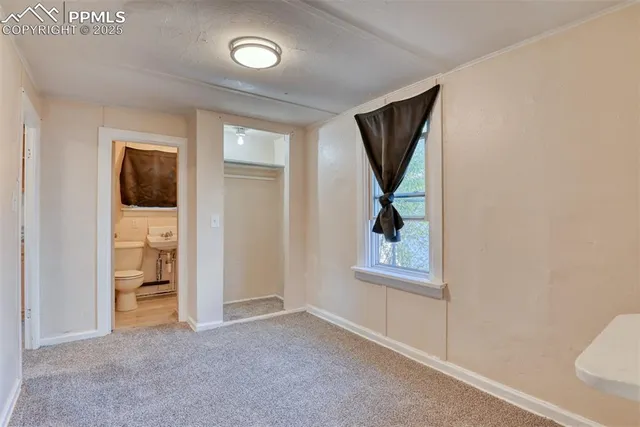 a bathroom with a sink and mirror with toilet