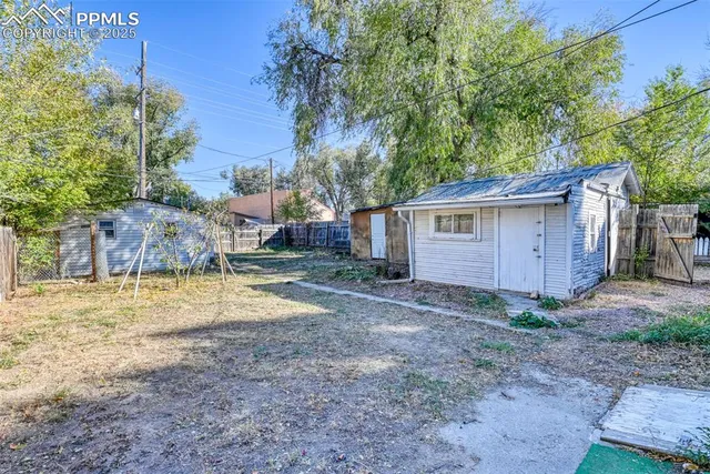 a view of a backyard with large tree