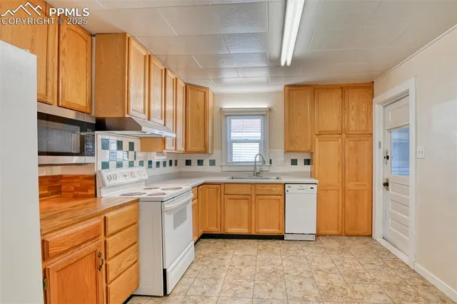 a kitchen with a sink stove and refrigerator