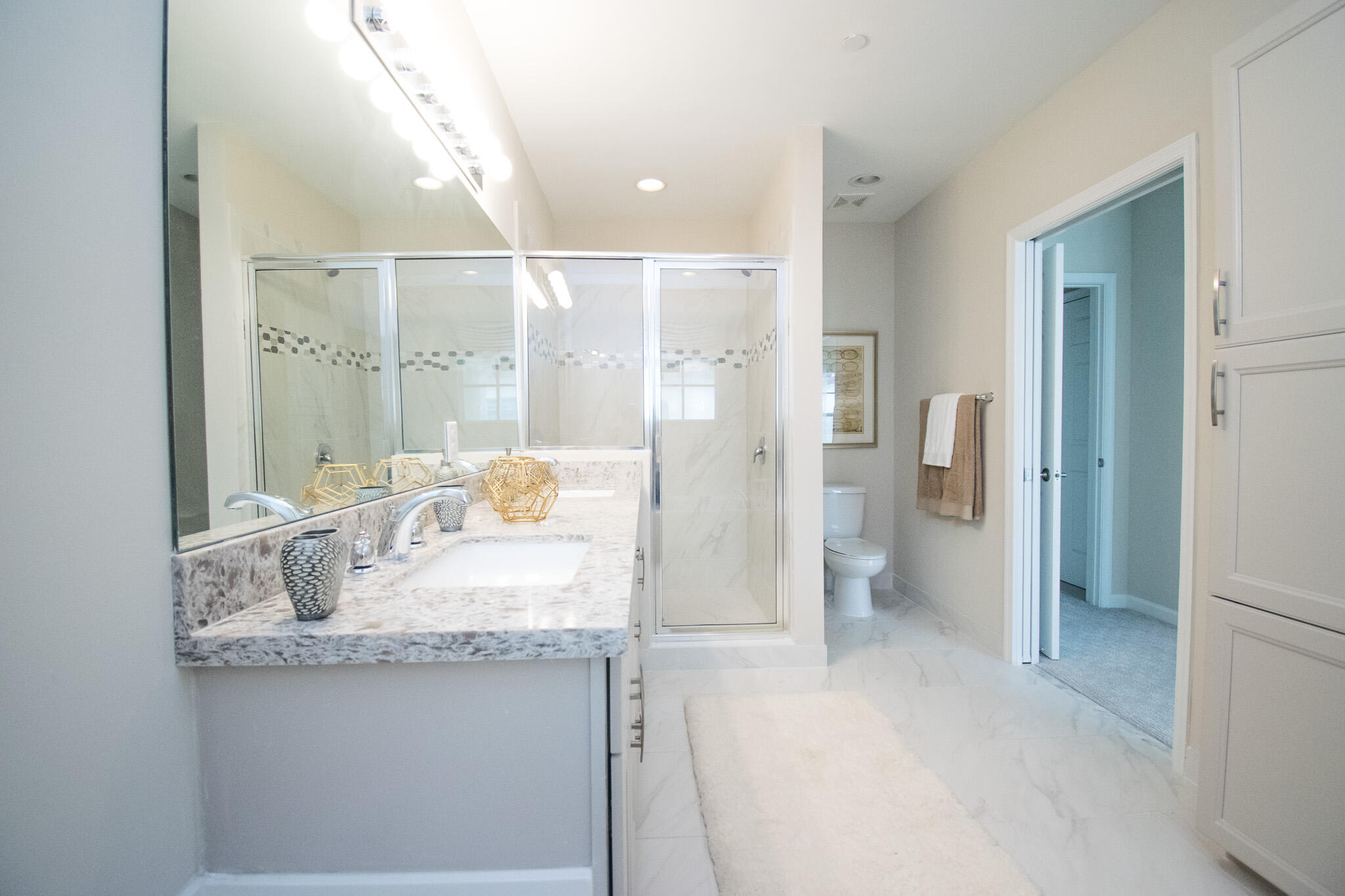 14377 Sims Road, Unit 14390 Delray Beach, FL 33484 - Photo 8 of 13 a bathroom with a granite countertop sink a toilet and shower