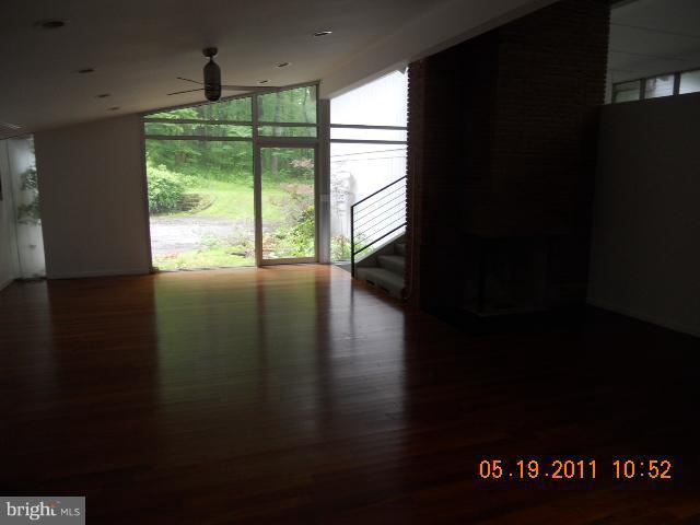 2403 Logan Road Owings Mills, MD 21117 - Photo 5 of 15 a view of an empty room with wooden floor and a window