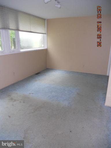 2403 Logan Road Owings Mills, MD 21117 - Photo 7 of 15 a view of an empty room with wooden floor and windows