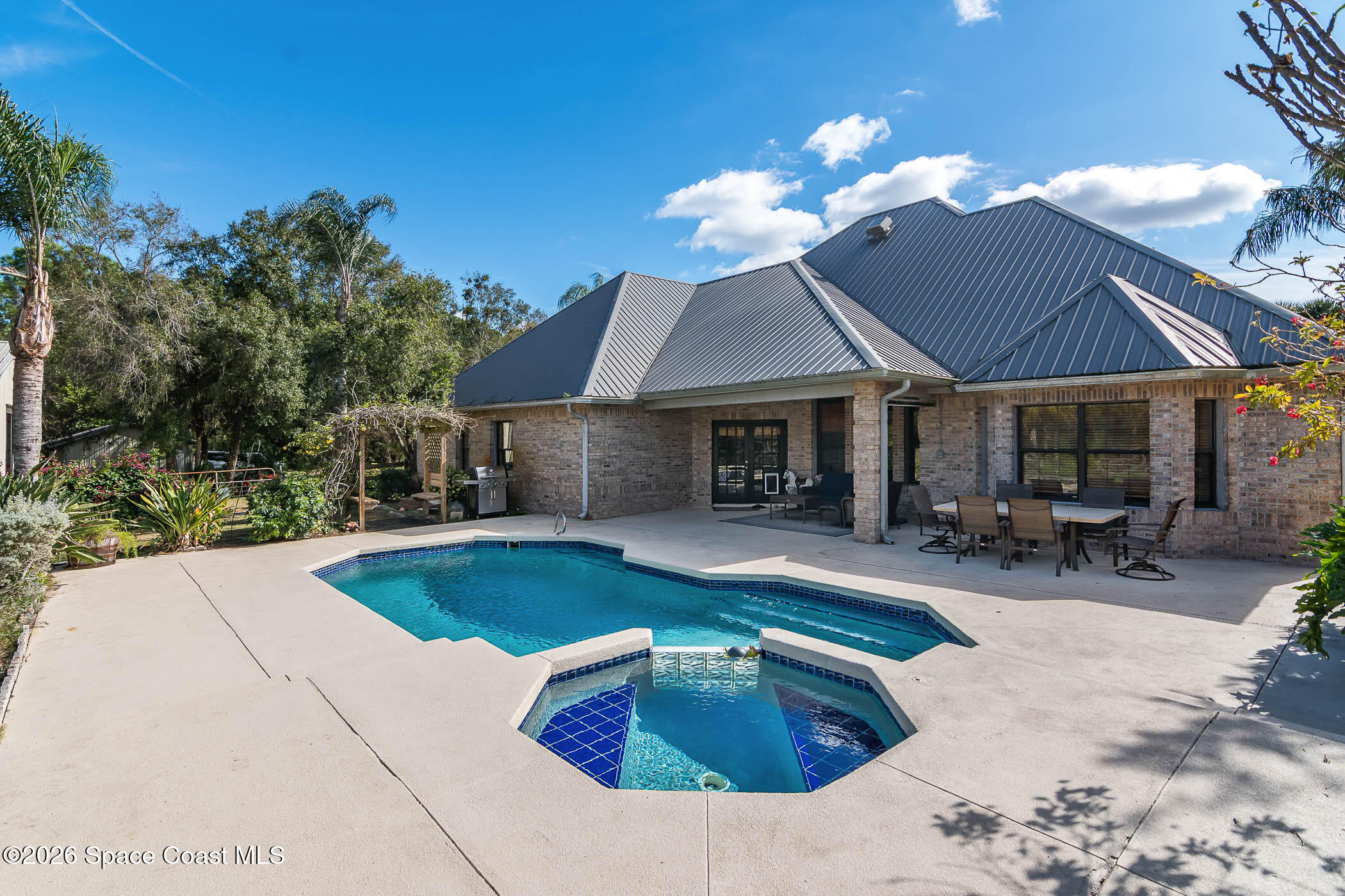 5101 Craig Road Cocoa, FL 32926 - Photo 26 of 62 a view of a house with swimming pool and sitting area