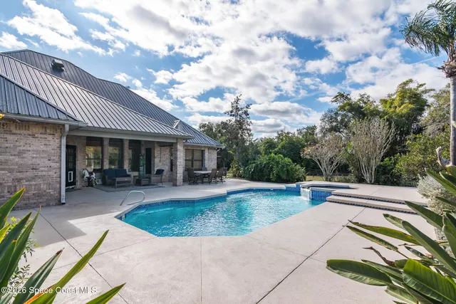 a view of an ocean beach and trees in the background