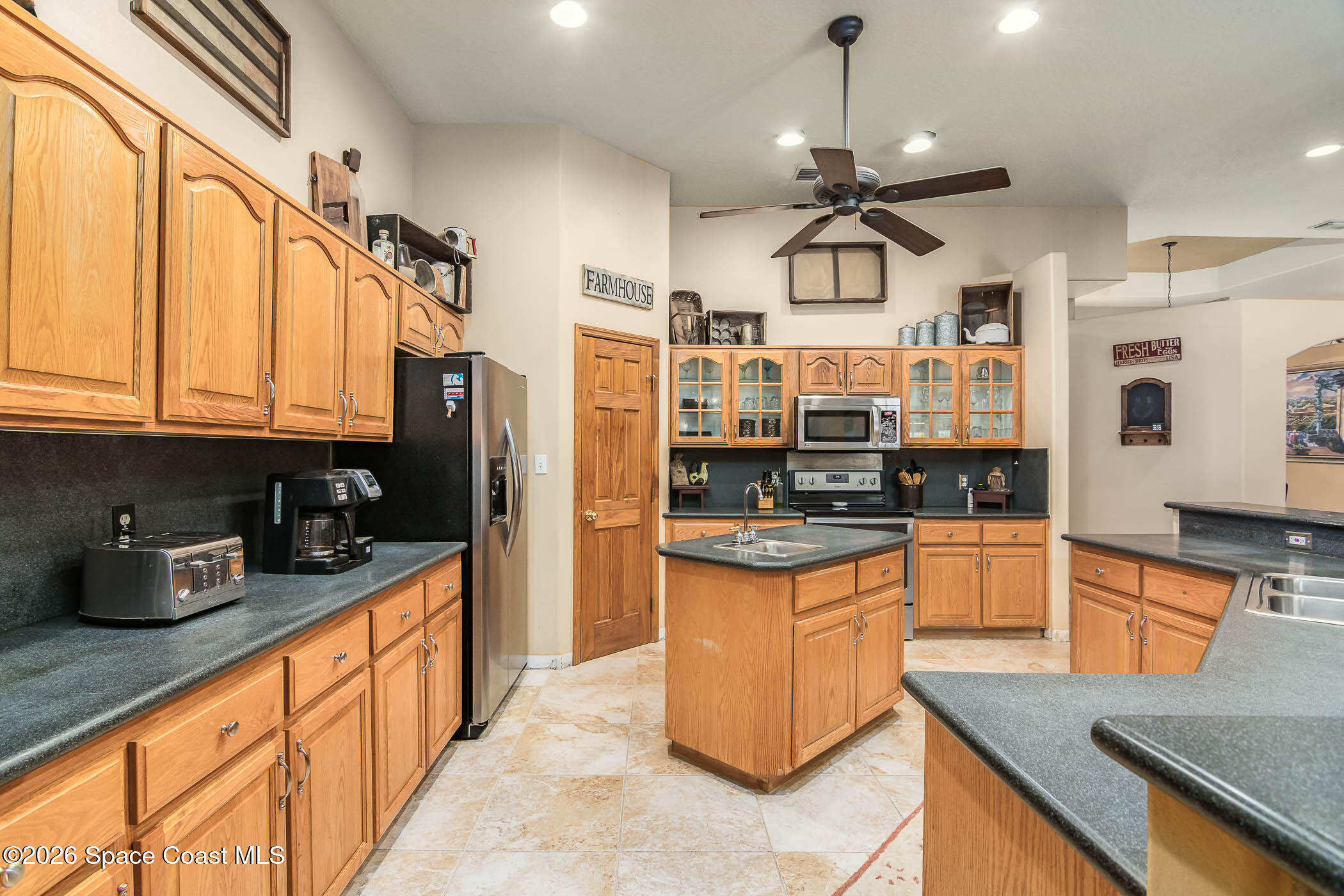 5101 Craig Road Cocoa, FL 32926 - Photo 37 of 62 a kitchen with stainless steel appliances granite countertop a sink a stove and a wooden cabinets