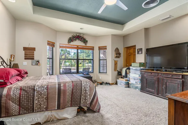 a bedroom with natural light and wooden door