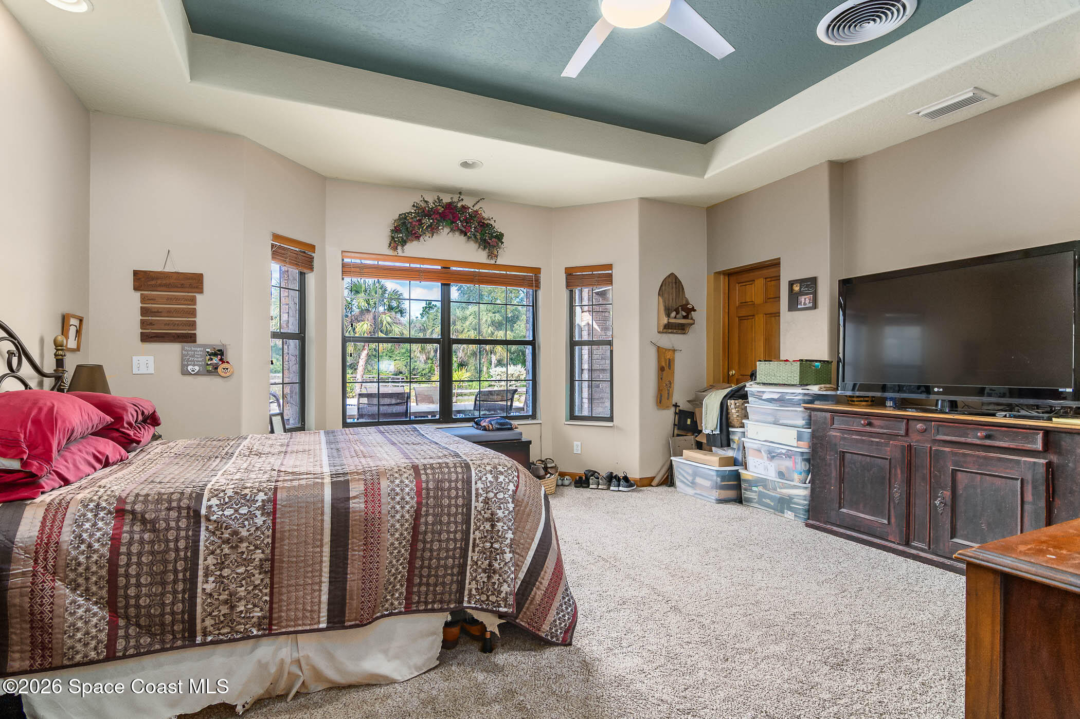 5101 Craig Road Cocoa, FL 32926 - Photo 42 of 62 a bedroom with a bed and a flat tv screen on dresser