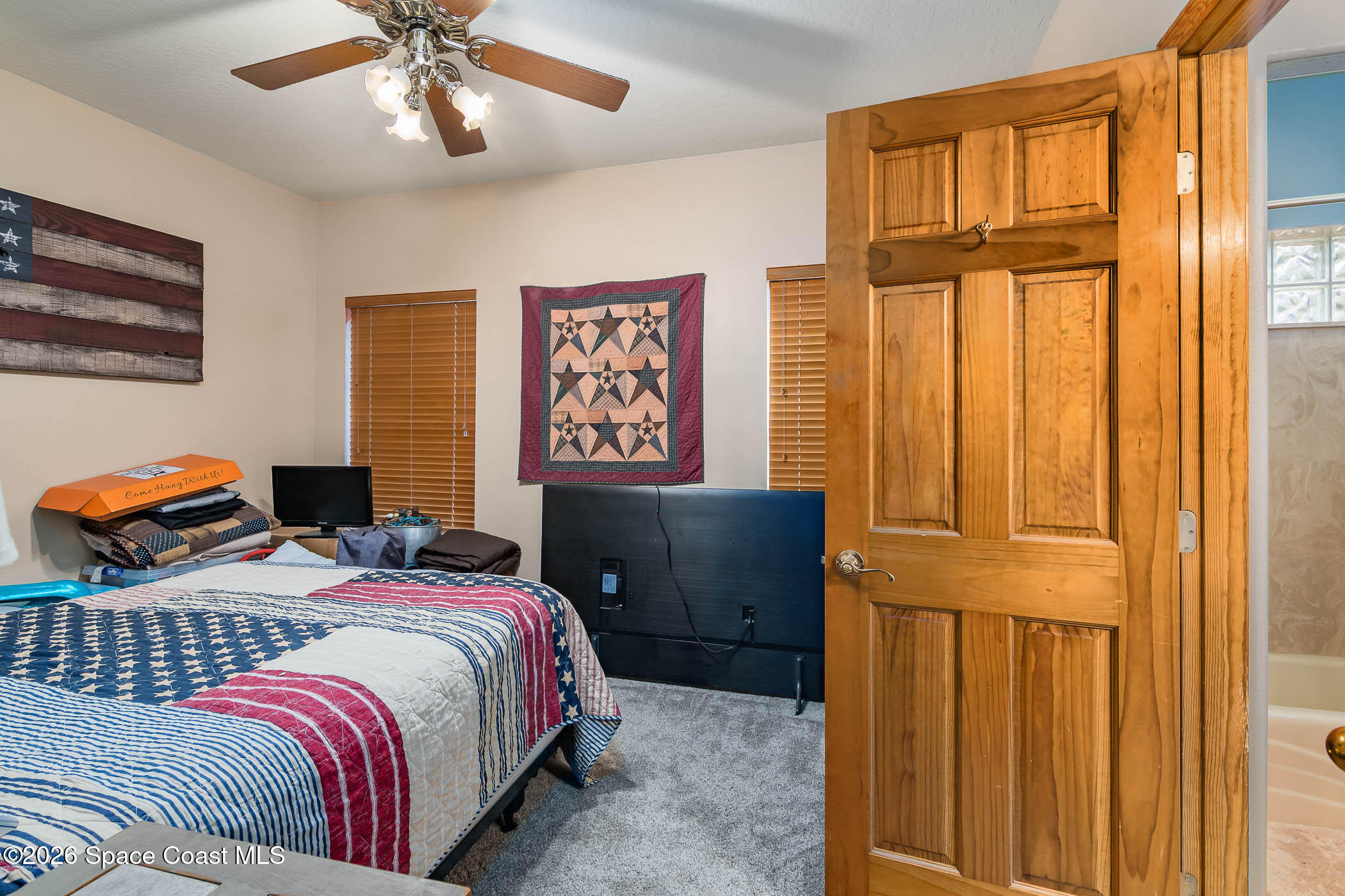 5101 Craig Road Cocoa, FL 32926 - Photo 49 of 62 a bedroom with natural light and wooden door