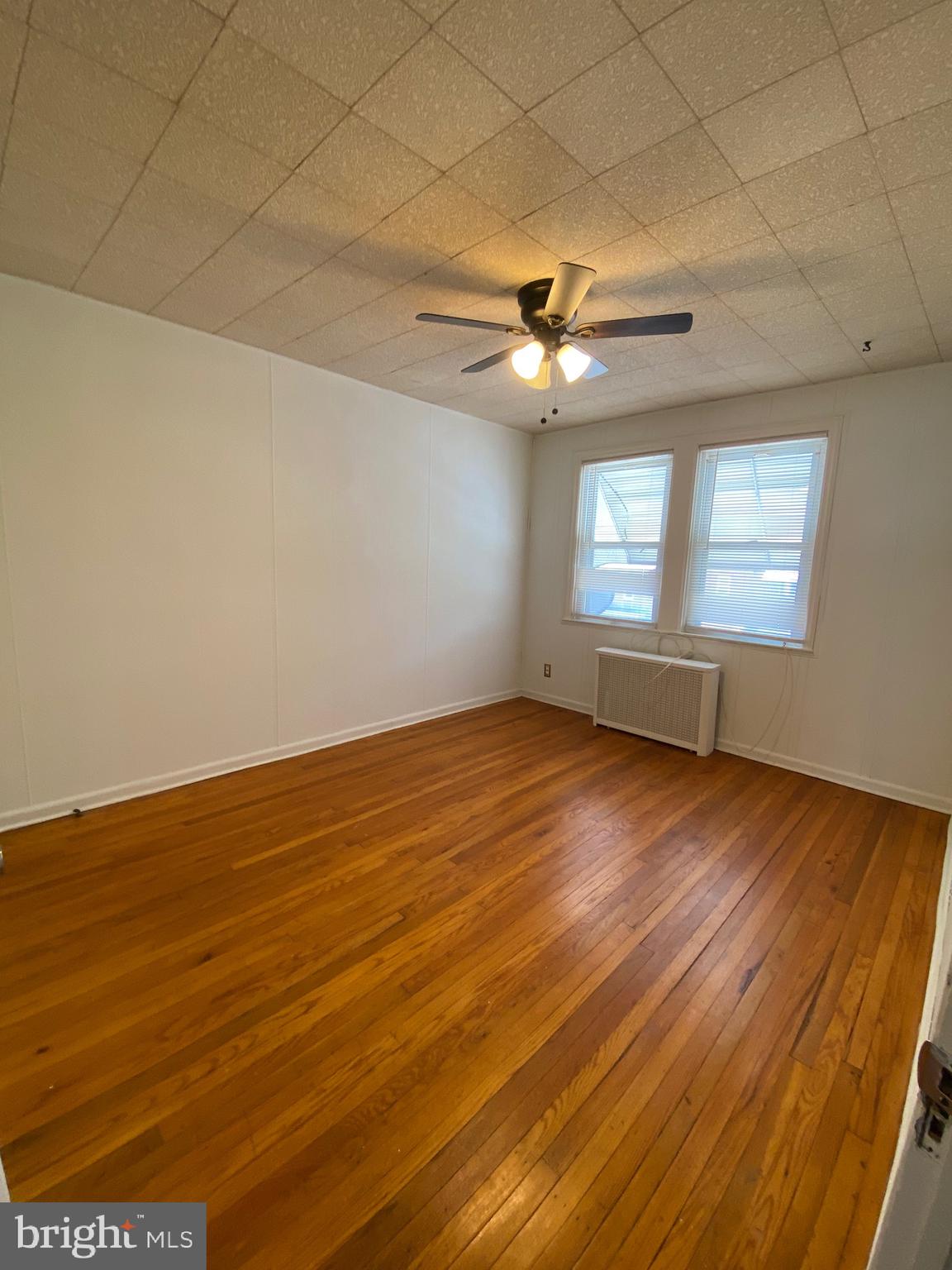 4010 Century Road Baltimore, MD 21206 - Photo 12 of 17 an empty room with wooden floor and windows