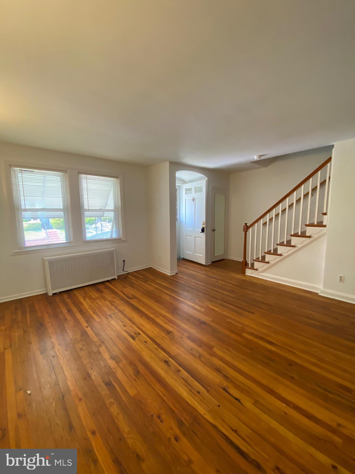 4010 Century Road Baltimore, MD 21206 - Photo 4 of 17 a view of an empty room with wooden floor and window