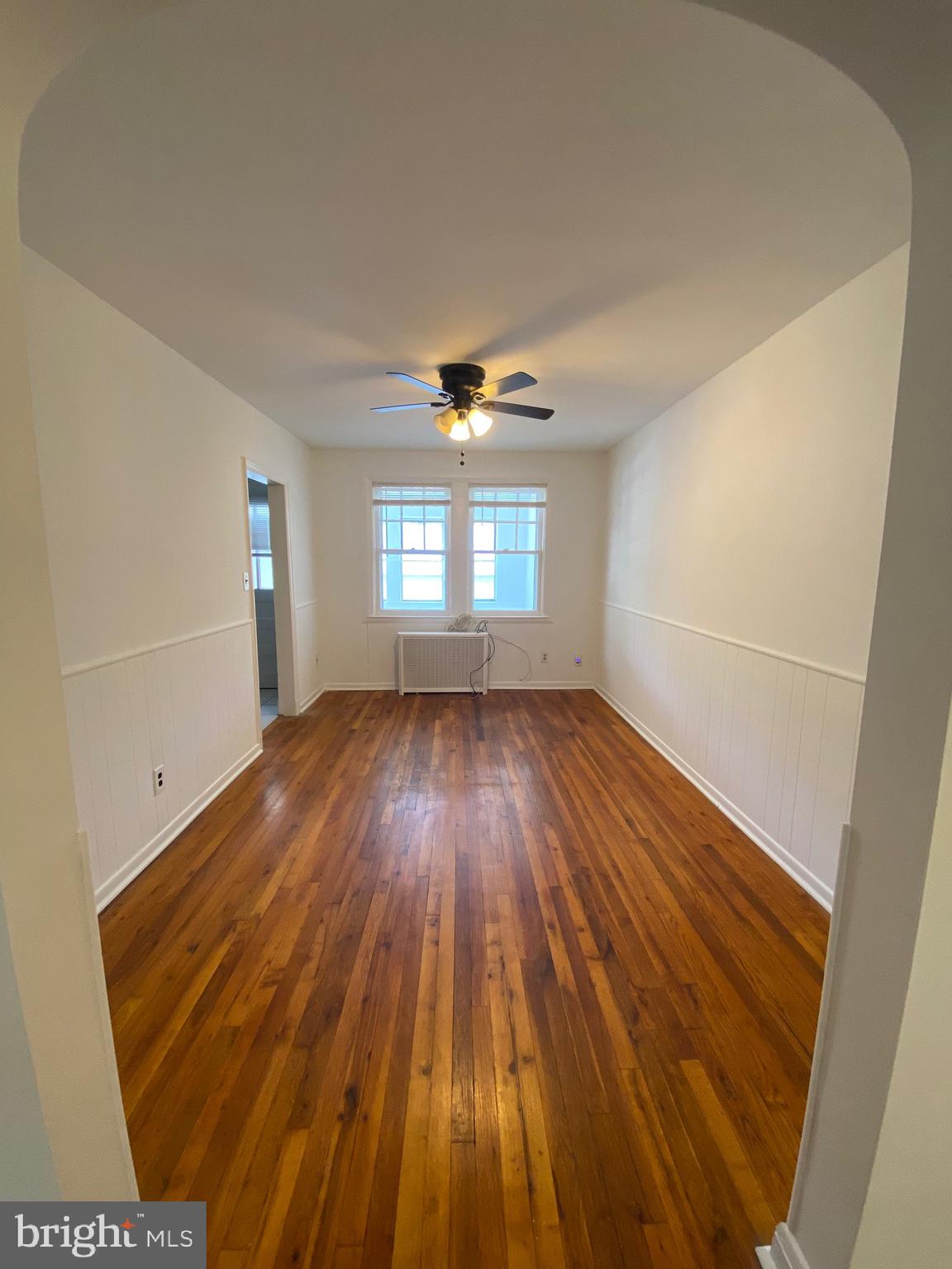 4010 Century Road Baltimore, MD 21206 - Photo 5 of 17 wooden floor in an empty room with a window