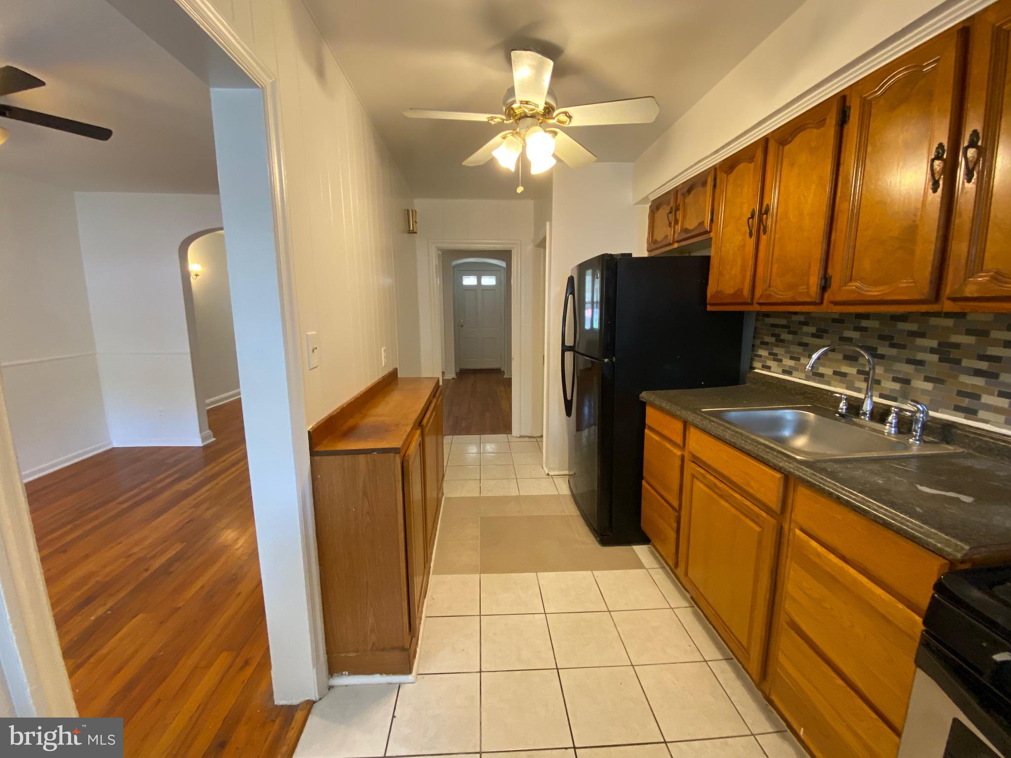 4010 Century Road Baltimore, MD 21206 - Photo 7 of 17 a kitchen with granite countertop a refrigerator a stove and a sink