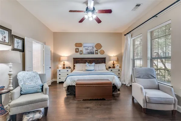 a bedroom with a bed dresser and a flat tv screen