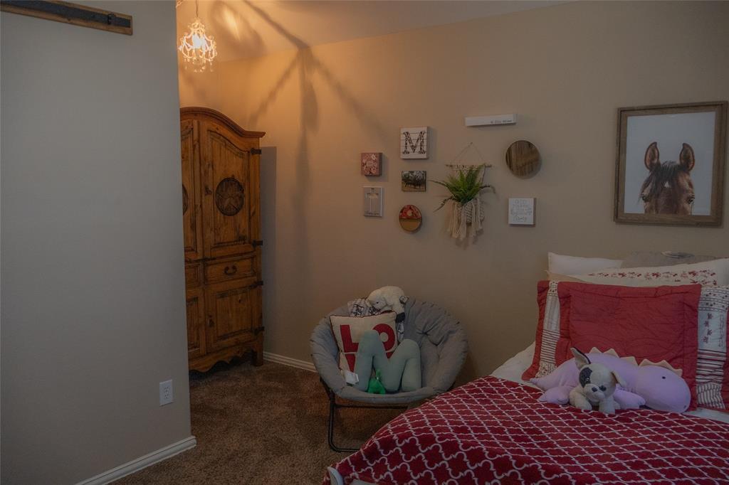 1395 Southern Rockwall, TX 75087 - Photo 17 of 22 a bedroom with a bed and wooden floor