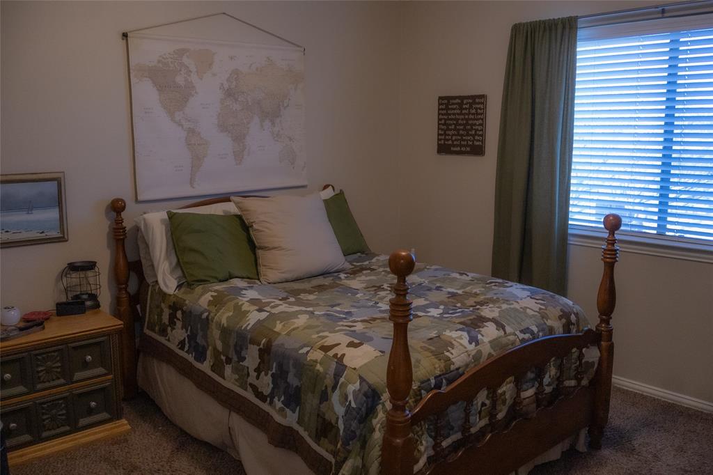 1395 Southern Rockwall, TX 75087 - Photo 19 of 22 a bed sitting in a bedroom next to a window