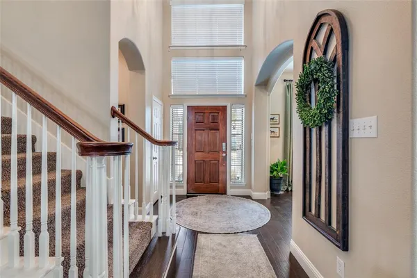 a view of entryway livingroom and hall with wooden floor