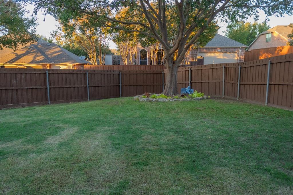 1395 Southern Rockwall, TX 75087 - Photo 21 of 22 a view of a backyard with a fence and trees