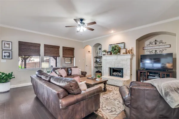 a living room with fireplace furniture and a large window