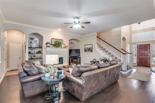 a living room with furniture kitchen view and a chandelier