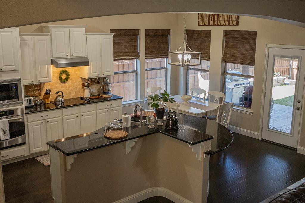 1395 Southern Rockwall, TX 75087 - Photo 5 of 22 a kitchen with a sink a stove and cabinets