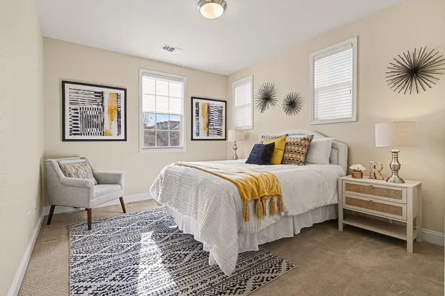 a bedroom with a bed and a chair