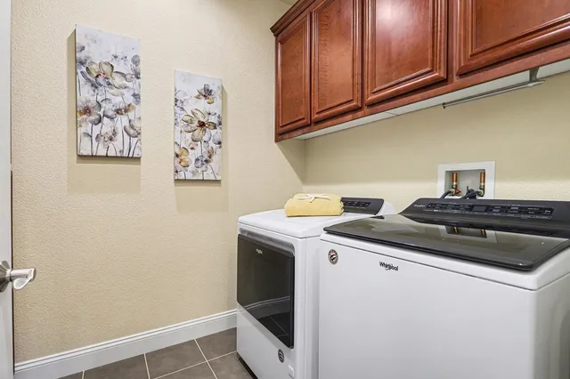 a view of a storage and utility room with washer and dryer