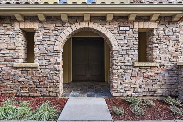a front view of a house with a garden