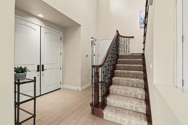a view of staircase with white walls and railing