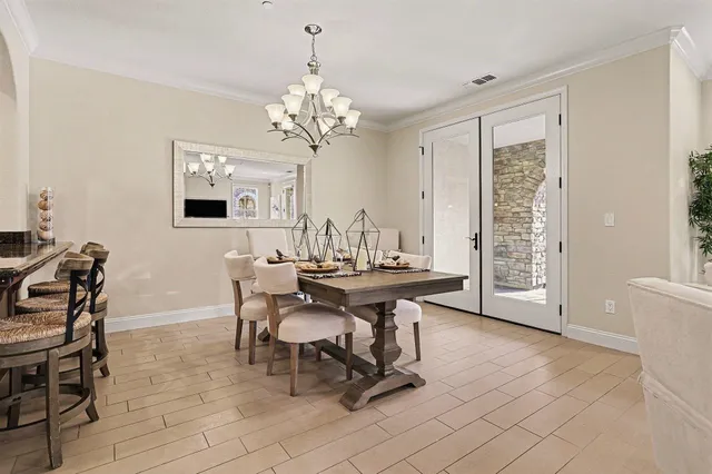 a view of a dining room with furniture and chandelier