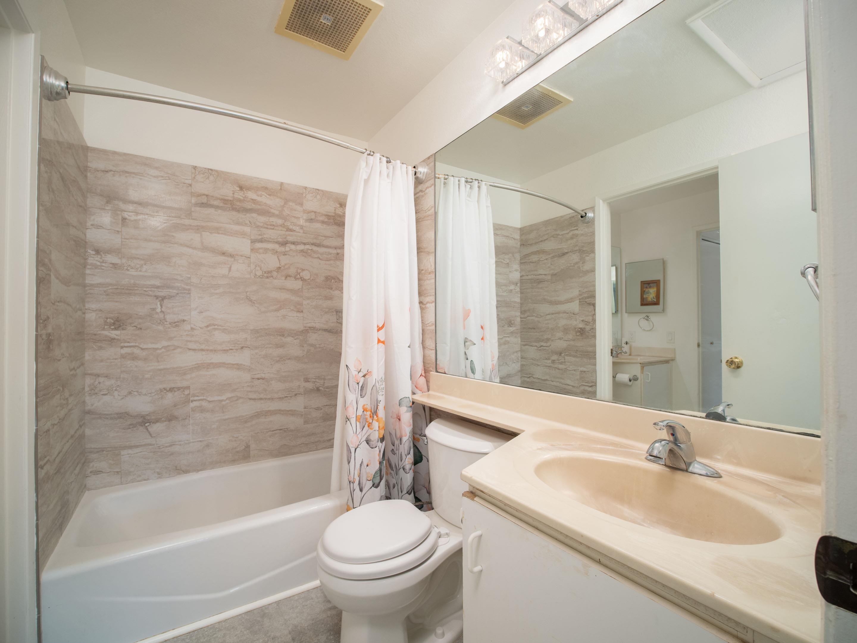 480 Kenolio Road, Unit 30206 Kihei, HI 96753 - Photo 12 of 20 a bathroom with a sink toilet and shower