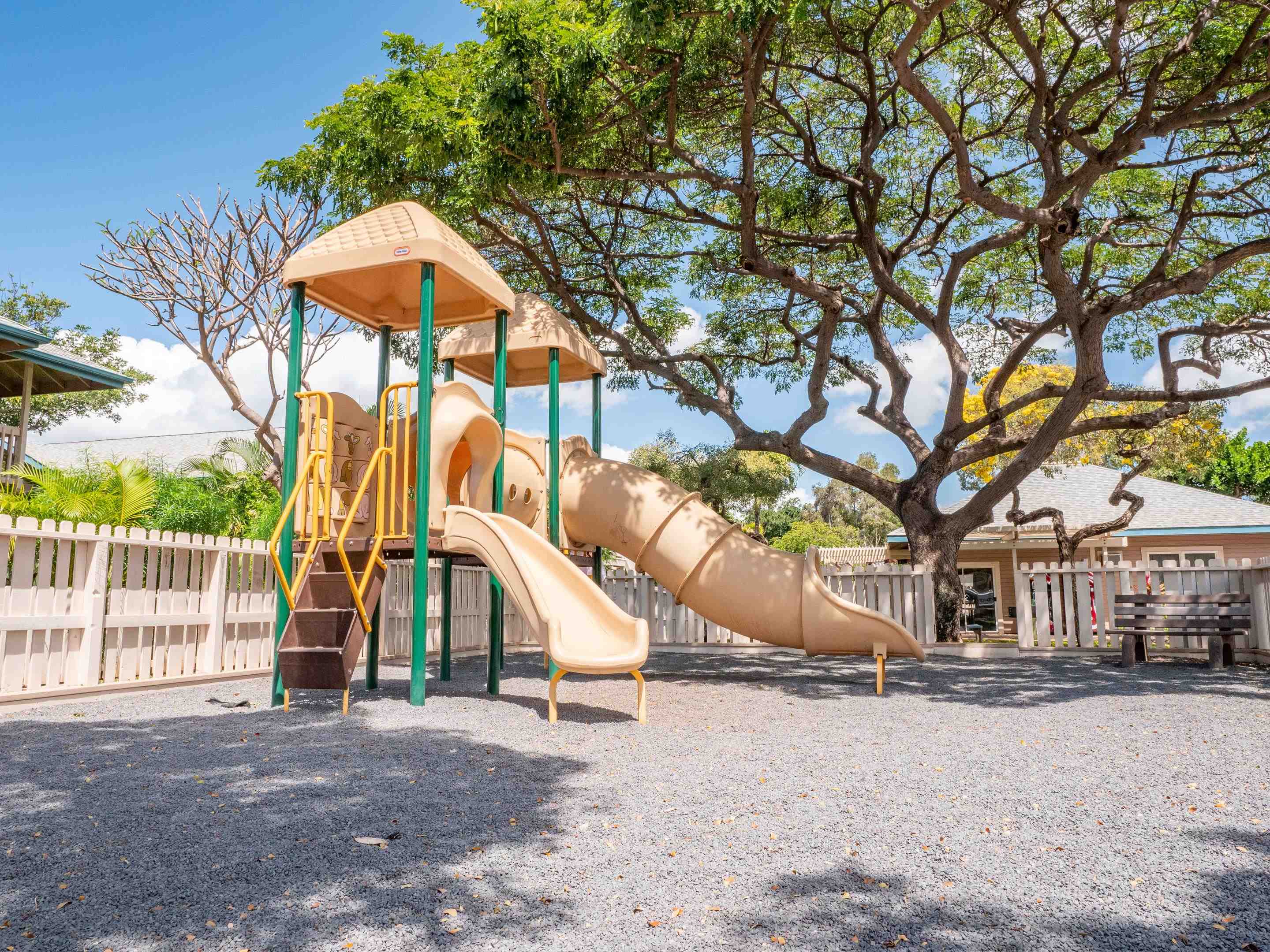 480 Kenolio Road, Unit 30206 Kihei, HI 96753 - Photo 16 of 20 a view of a large white house with a yard and wooden fence