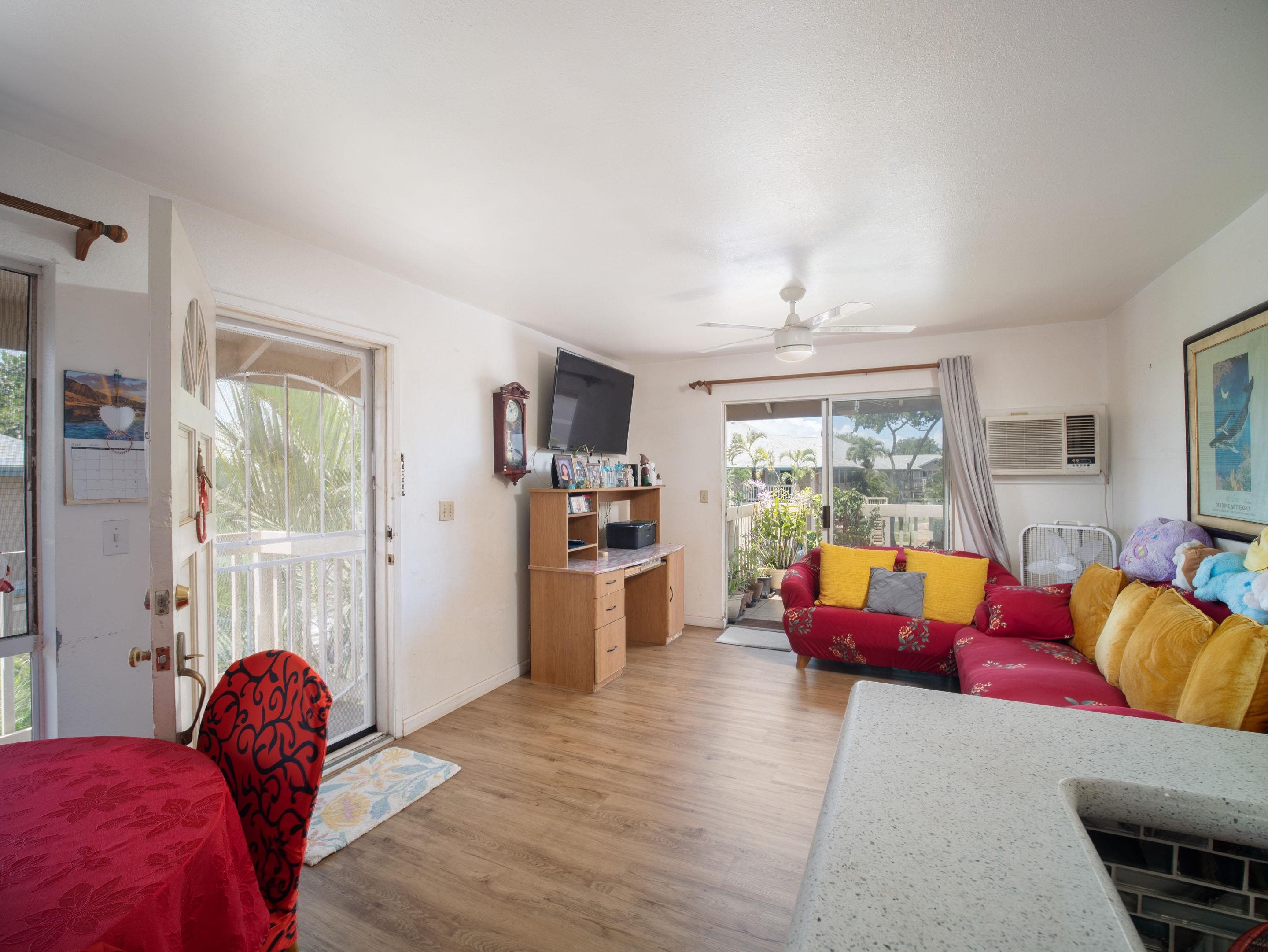 480 Kenolio Road, Unit 30206 Kihei, HI 96753 - Photo 2 of 20 a living room with furniture and a large window