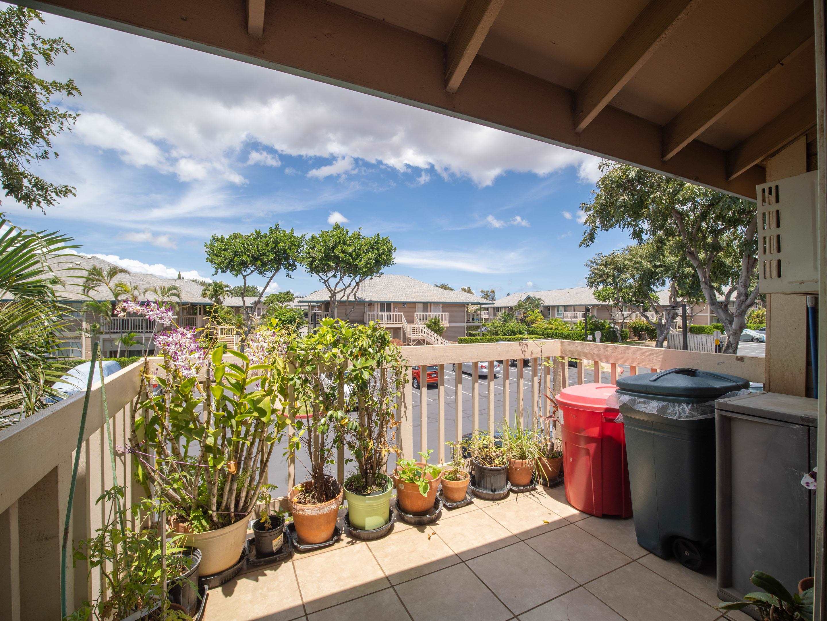 480 Kenolio Road, Unit 30206 Kihei, HI 96753 - Photo 7 of 20 a view of a patio with table and chairs potted plants