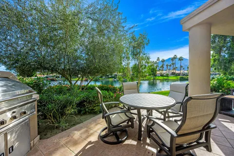 a view of a chairs and table in the patio