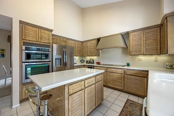 a kitchen with a sink cabinets and stainless steel appliances
