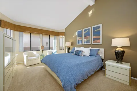 a living room with a bed furniture and a window